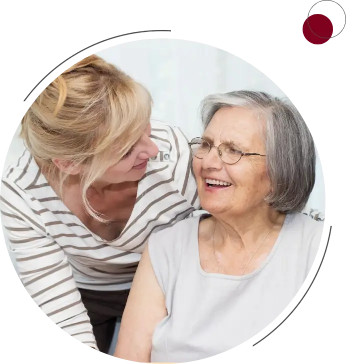 A woman and an older person smiling for the camera.